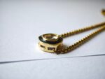 Close-up of Aaina bracelet — cushion kundan with forest green enamel rim on gold box chain, modern ethnic jewelry Pakistan Dango