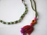 Fuchsia tassel detail of Zindagi dori necklace — hot pink and magenta tassel with orange wrapping, cultural ethnic necklace Pakistan Dango