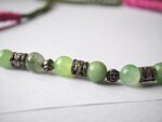 Close-up of Zindagi necklace — natural jade beads with oxidised silver spacers on olive dori, ethnic handmade jewelry Pakistan Dango