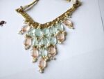 Close-up of Mehr-un-Nisa choker bib — handwoven gold mesh with aqua and blush tumble drops and ivory pearl clusters, premium bridal jewelry Pakistan Dango