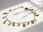 Rang green zircon charm bracelet — gold plated chain with peridot baguette zircons and gold ball charms, Meraki collection by Dango Pakistan