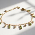 Rang green zircon charm bracelet — gold plated chain with peridot baguette zircons and gold ball charms, Meraki collection by Dango Pakistan