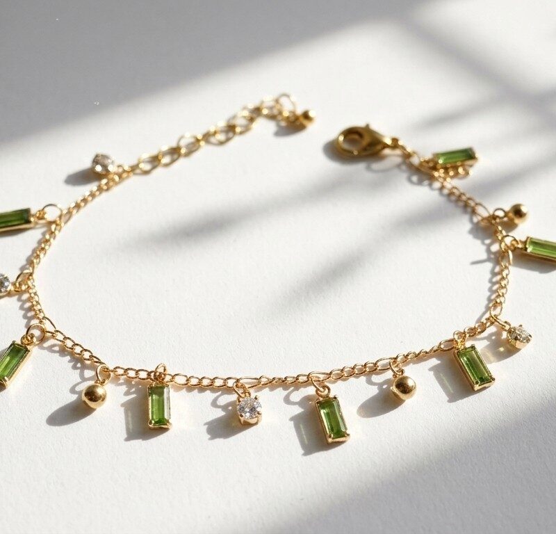 Rang green zircon charm bracelet — gold plated chain with peridot baguette zircons and gold ball charms, Meraki collection by Dango Pakistan