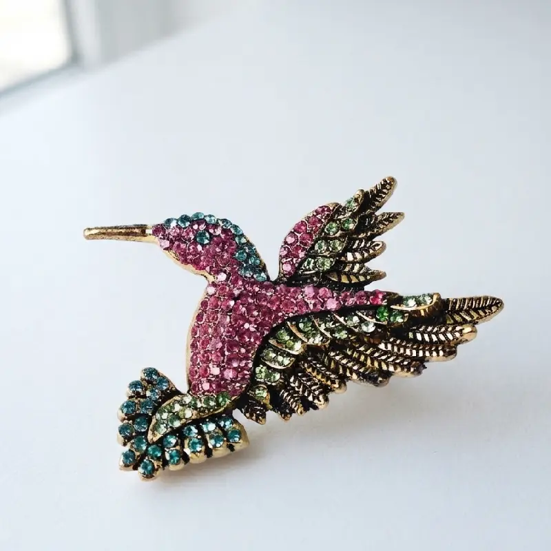 Dango 5x5cm vintage crystal hummingbird brooch made of alloy with multi-colored rhinestones, displayed flat on a clean surface, available in Pakistan.