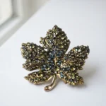 Dango 5x5cm vintage green crystal leaf brooch made of alloy, displayed flat on a clean surface, available in Pakistan.
