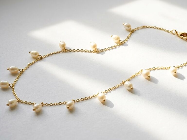 Dango 18K gold plated chain necklace with dangling freshwater pearls resting on a white background.