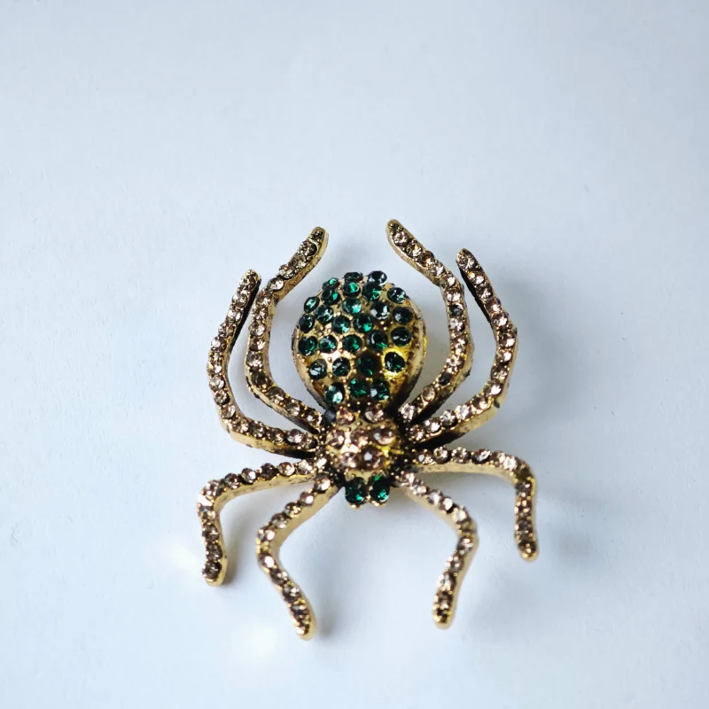 Dango 1.8x1.35 inches vintage green crystal spider brooch made of alloy with rhinestones, displayed flat on a clean surface, available in Pakistan.
