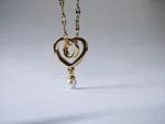 Dango gold plated stainless steel chain with a 10mm plated copper interlocking heart and pearl pendant, displayed against a clean background in Pakistan.