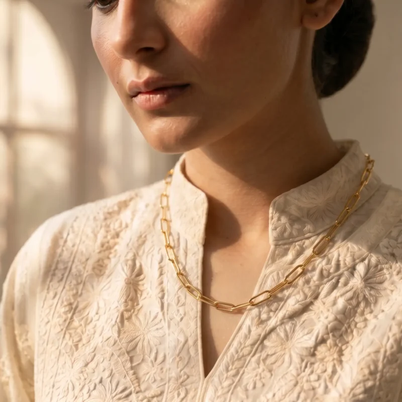 Model in Pakistan wearing the Dango gold plated stainless steel paperclip chain necklace alone against her neckline.