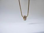 Dango gold plated stainless steel PVD chain with a 7mm zircon wheel pendant, displayed against a clean background in Pakistan.