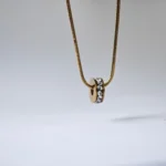 Dango gold plated stainless steel PVD chain with a 7mm zircon wheel pendant, displayed against a clean background in Pakistan.