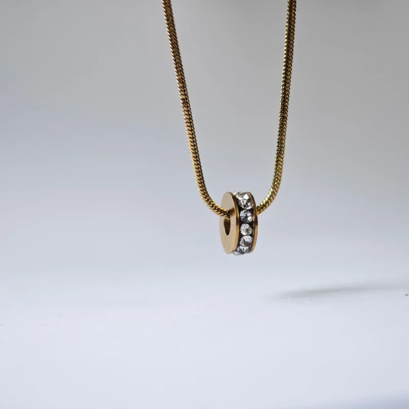 Dango gold plated stainless steel PVD chain with a 7mm zircon wheel pendant, displayed against a clean background in Pakistan.